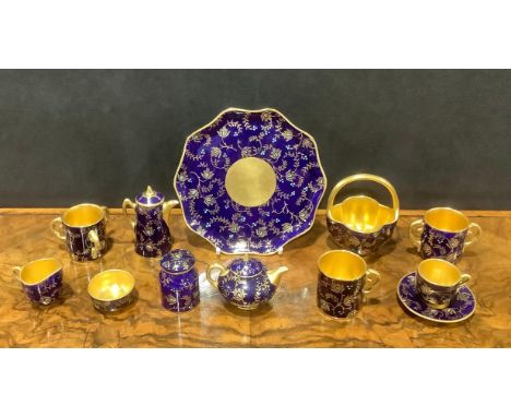 A Coalport miniature tea service, comprising teapot, coffee pot, cream jug, sugar bowl, tea cup and saucer, on shaped circula