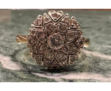A diamond cluster ring, eight point star and heart crest set with twenty five round old brilliant cut diamonds, total estimat