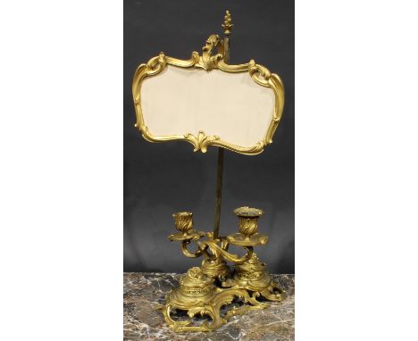 A 19th century ormolu combination study lamp and standish, with cartouche shaped shade and a pair of candle sconces, cast thr