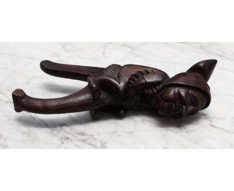 Nutcrackers - a Black Forest novelty lever-action nut cracker, carved as a gnome, 27cm long, early 20th century 