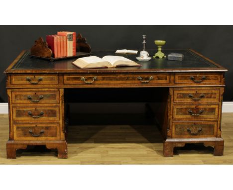 A George III Revival walnut and mahogany twin pedestal partners’ desk, rectangular top with inset tooled and gilt writing sur