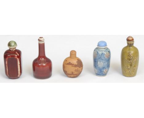 A 19th century Chinese snuff bottle, decorated with stylised red flowers on a scale blue ground, pale blue stopper, 7.5cm hig