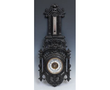 A 19th century gutta percha aneroid barometer, 9.5cm register, the case moulded in the Historicist taste and crested by a her