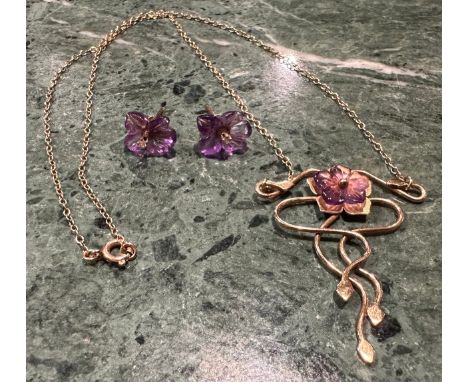 A diamond and amethyst pendant and similar earrings suite, Art Nouveau style serpentine floral pendant with carved amethyst p