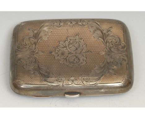 A Victorian silver rounded rectangular cigar case, bright-cut engraved with cartouches of scrolling foliage, on an engine tur