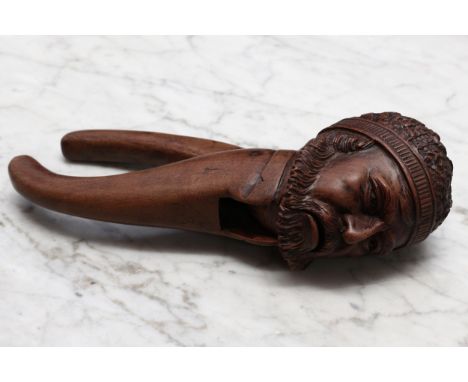 Nutcrackers - a Continental walnut novelty lever-action nut cracker, carved as the head of a bearded man, possibly Pythagoras