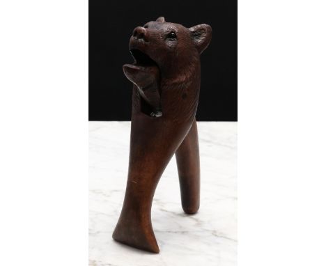 Nutcrackers - a Black Forest novelty lever-action nut cracker, carved as the head of a bear, glass eyes, 19cm long, c.1900 