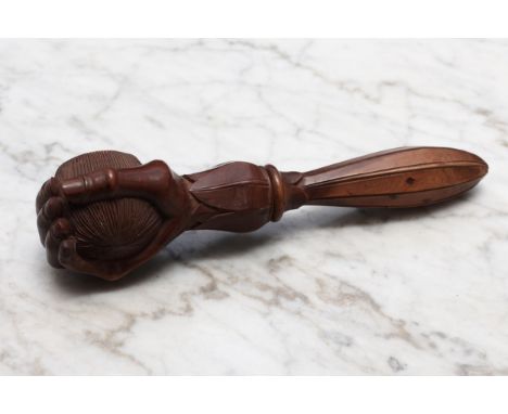 Nutcrackers - a Black Forest novelty screw-action nut cracker, carved as a fist grasping a walnut, lotus grip, 17.5cm long, c