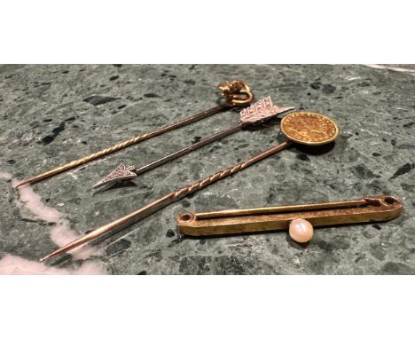 A USA Indian princess gold One Dollar stick pin, the coin dated 1857; a gold coloured metal snake head stick pin, the eyes se