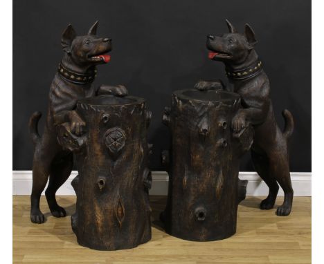 A pair of mid-20th century Black Forest design hardwood animalier walking stick or umbrella stands, each carved as a dog rest