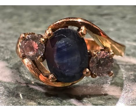 A blue and white sapphire ring, twisted crest with central oval deep blue sapphire approx 1.50ct between two round brilliant 