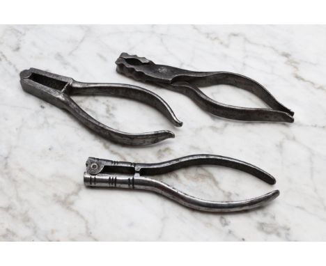 Nutcrackers - an 18th century steel pincer-action nut cracker, 13.5cm long, c.1750; others, similar, lever-action (3) 