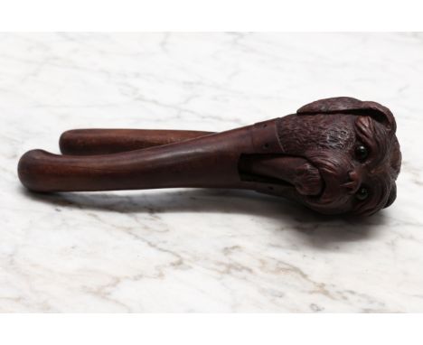 Nutcrackers - a Black Forest novelty lever-action nut cracker, carved as the head of a dog, wearing a collar, glass eyes, 19.