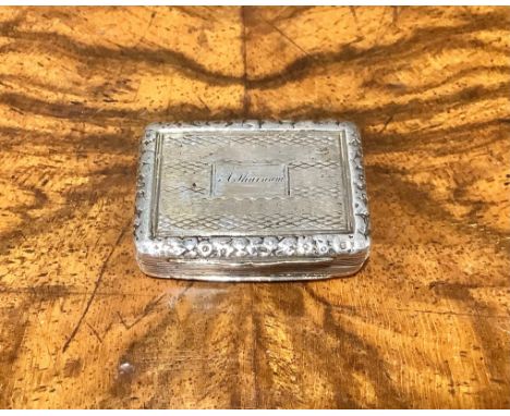 A George IV silver rectangular vinaigrette, engine turned, foliate borders, gilt interior with pierced grille, 3.5cm wide, Th
