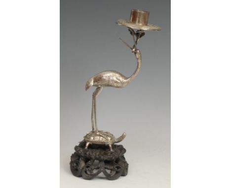 A Chinese silver candlestick, as a crane standing on a turtle, pierced and carved hardwood base, 24.5cm high, apparently unma
