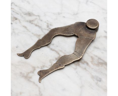 Nutcrackers - an 18th century brass nut cracker, as a pair of legs, 11cm long 