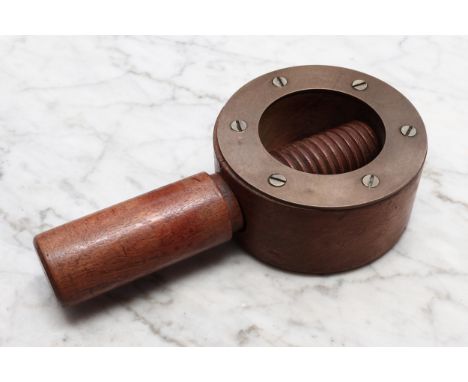 Nutcrackers - a large early 20th century brass bound walnut screw-action nut cracker, 18.5cm long 