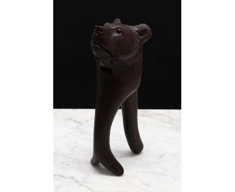 Nutcrackers - a Black Forest novelty lever-action nut cracker, carved as the head of a bear, glass eyes, 17cm long, early 20t