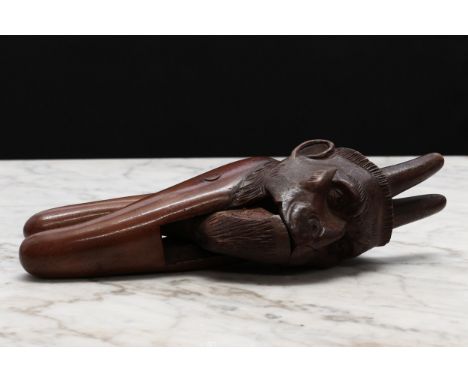 Nutcrackers - a Black Forest novelty lever-action nut cracker, carved as bearded man with devil or cuckold horns, 19.5cm long