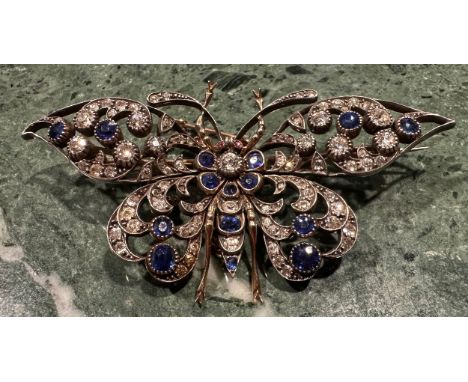 A late Victorian/Edwardian diamond, sapphire and ruby encrusted butterfly brooch, the unmarked yellow metal open butterfly fr