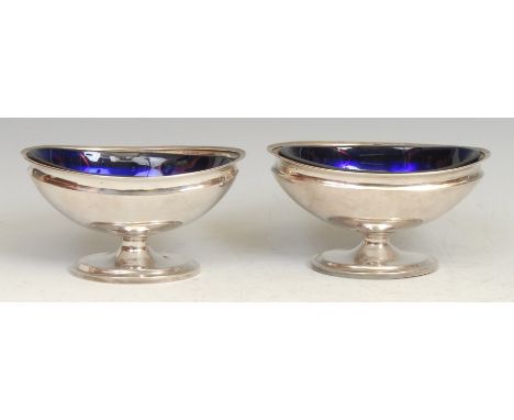 A pair of Chinese silver oval pedestal salts, blue glass liners, 11cm wide, character marks, c.1890, 140g 