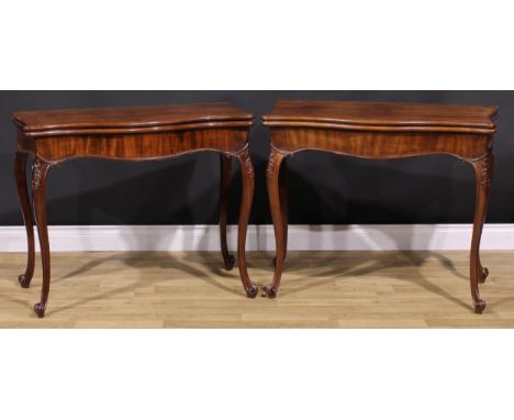 A pair of George III mahogany serpentine card tables, in the French Hepplewhite manner, each with a hinged top enclosing a ba