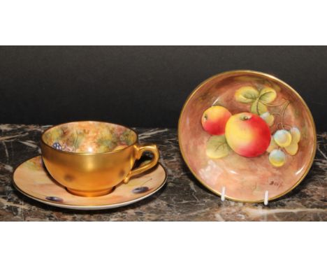 A Royal Worcester cabinet cup and saucer, painted by John Freeman, signed, with peaches, blackberries and cherries on a mossy