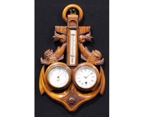 An early 20th century wall hanging combination aneroid barometer, thermometer and timepiece, of maritime interest, carved as 