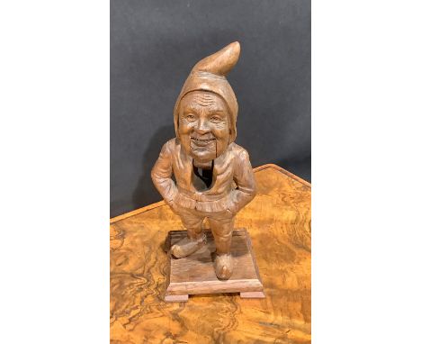 A Black Forest novelty lever-action nut cracker, carved as a gnome, 24.5cm high, c.1900 