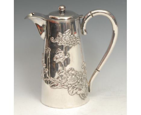 A Chinese silver hot water jug, applied with butterflies and blossoming branches, hinged cover, 19cm high, c.1900, 526g 