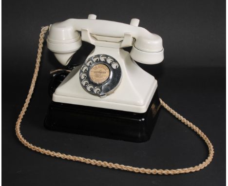 A GPO No 164 telephone, ivory colour enclosure, chrome dial, No 18 earpiece, the handset stamped PL37 G.P.O No164 234, c.1938