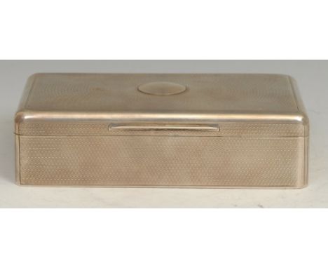 A George V silver rounded rectangular cigar box, engine turned overall, the hinged cover centred by a vacant circular cartouc