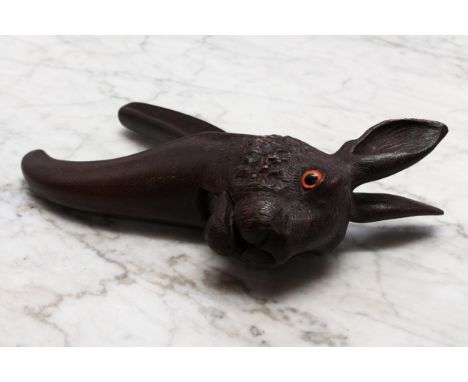 Nutcrackers - a Black Forest novelty lever-action nut cracker, carved as the head of a hare, glass eyes, 23.5cm long, early 2