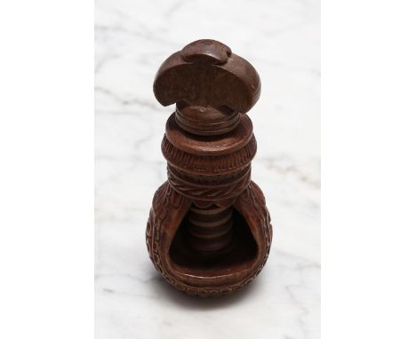 Nutcrackers - a 19th century Swiss acorn shaped screw-action nut cracker, carved with a band of lotus and turned throughout w