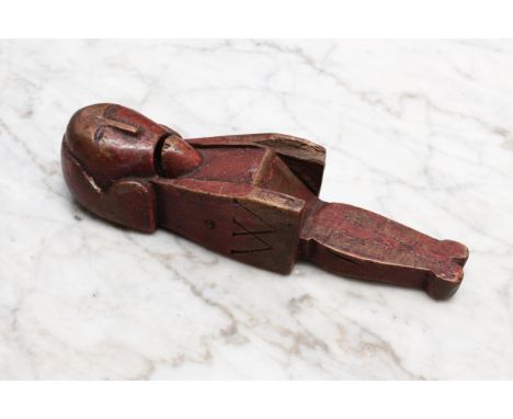 Nutcrackers - a late 17th century softwood figural lever-action nut cracker, carved as gentleman wearing a queue wig, unusual