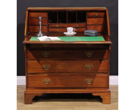 A George III mahogany bureau, fall front enclosing small drawers and pigeonholes, above four long graduated drawers, brass sw