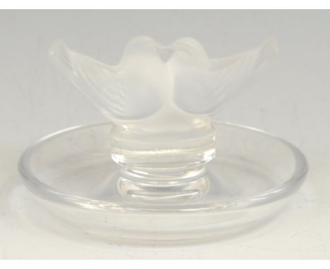 A Lalique Lovebirds ring tray, applied with a pair of frosted glass birds in an embrace, 6cm high, 10cm diameter, engraved ma