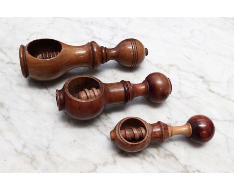 Nutcrackers - an early 19th century French boxwood screw-action nut cracker, compressed globular pommel, 13cm long, c.1820; a
