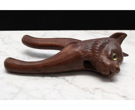 Nutcrackers - a Black Forest novelty lever-action nut cracker, carved as the head of a cat, glass eyes, the lever inscribed G