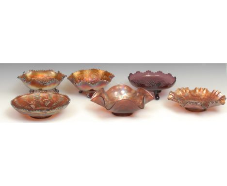 A carnival amethyst glass fluted dish, moulded with dragons and roses in relief, 21cm diameter; a similar pedestal dish; four