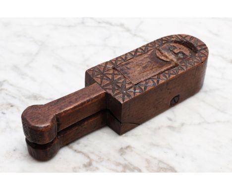 Nutcrackers - a 17th century style figural nut cracker, carved as a man, rudimentary features within a chequered border, 15cm