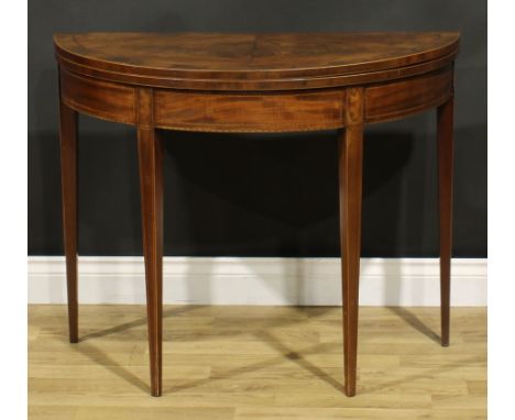 A George III mahogany demilune card table, hinged top enclosing a baize lined playing surface, tapered square legs, 72cm high