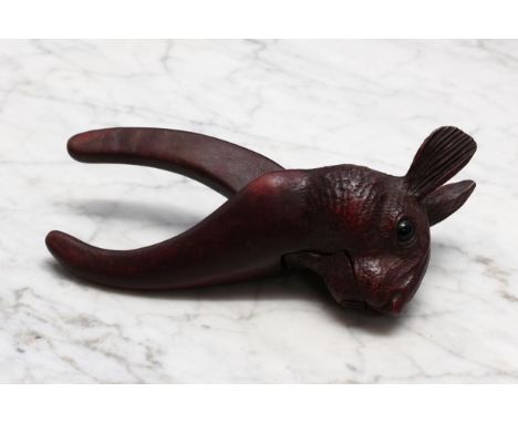 Nutcrackers - a Black Forest novelty lever-action nut cracker, carved as the head of a rabbit, glass eyes, 17cm long, early 2