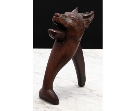 Nutcrackers - a Black Forest novelty lever-action nut cracker, carved as the head of a dog, glass eyes, 20cm long 