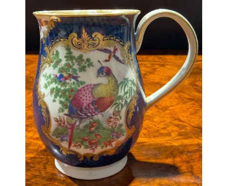 A large Worcester bell shaped mug, painted with fanciful birds within gilt cartouches, the scale blue ground with vasular res