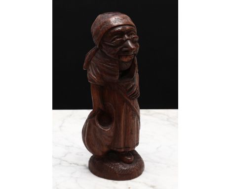 Nutcrackers - a 19th century Swiss novelty table top standing figural nut cracker, carved as a lady wearing spectacles, 21cm 