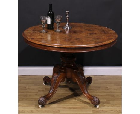 A Victorian walnut centre table, quarter-veneered oval tilting top, turned column, cabriole legs, ceramic casters, 74cm high,