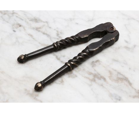 Nutcrackers - a 17th/early 18th century brass lever-action nut cracker, spirally fluted pillars, fluted knop finials10.5cm lo