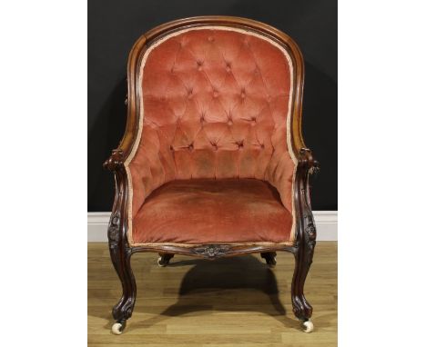 A Victorian walnut and mahogany library chair, stuffed-over upholstery, cabriole forelegs, ceramic casters, 90.5cm high, 68.5