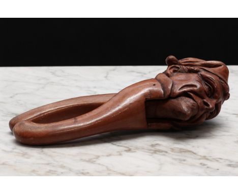Nutcrackers - a Black Forest novelty lever-action nut cracker, carved as a gentleman wearing a tasselled cap, 22cm long, c.19